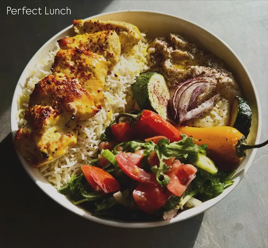 Mediterranean chicken tenders baking on a sheet pan until golden