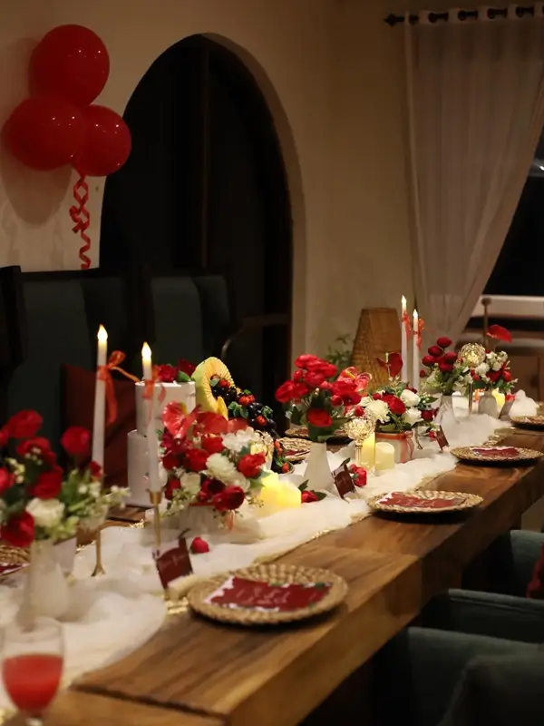 Beautiful birthday dinner table setting at home with candles and elegant plates