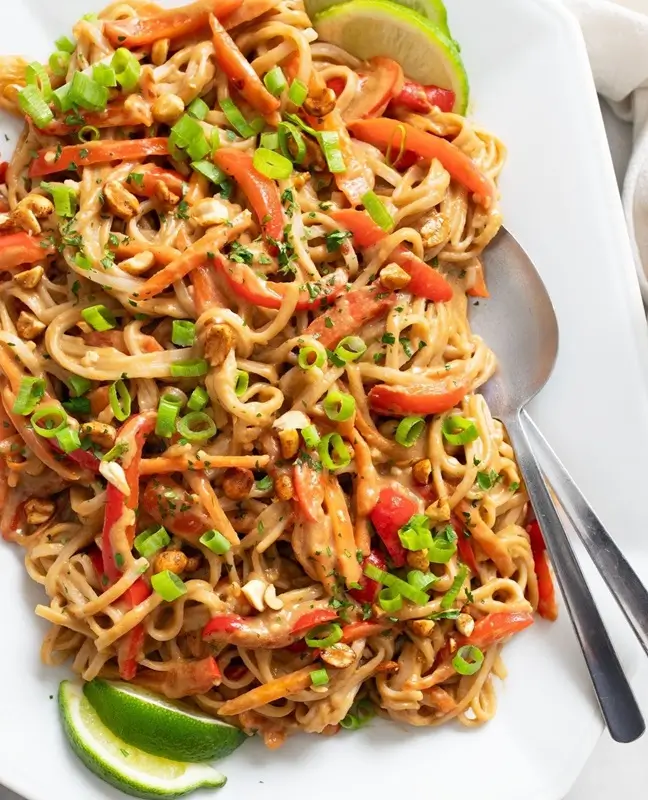 A bowl of peanut butter noodles with soy sauce and red pepper flakes, a cheap and easy college dinner idea