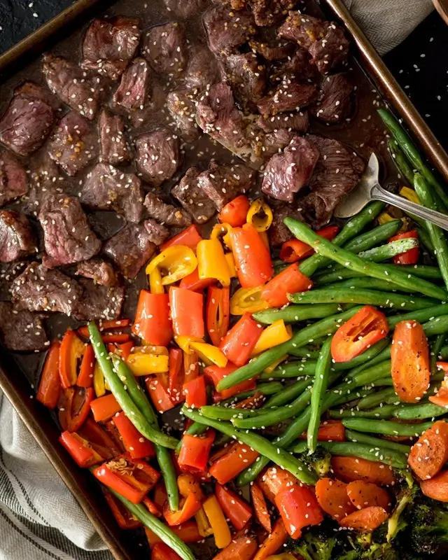 Caramelized and golden-brown roasted vegetables on a sheet pan showing the Maillard reaction in action