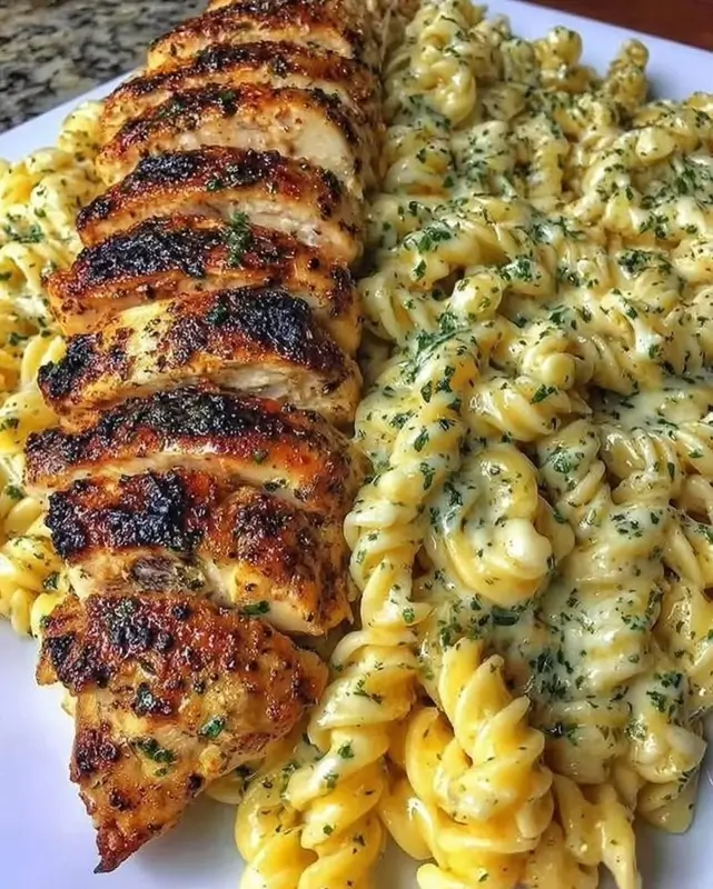 Creamy pesto chicken pasta bake in a rustic baking dish