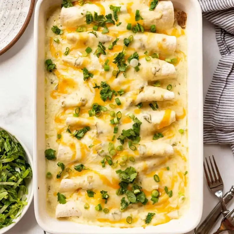 Baked white chicken enchiladas with golden melted cheese fresh from the oven